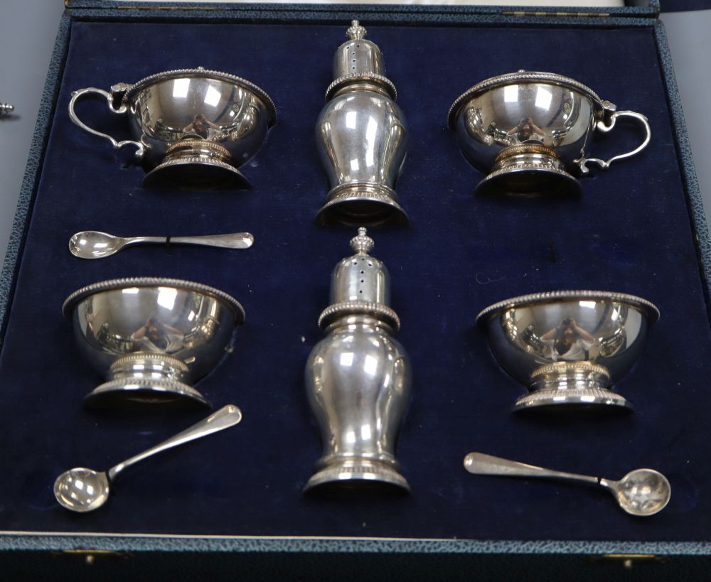 A cased silver six piece condiment set and three (ex four) spoons, William Comyns & Sons Ltd, London, 1959 & 1960, 15.5 oz,